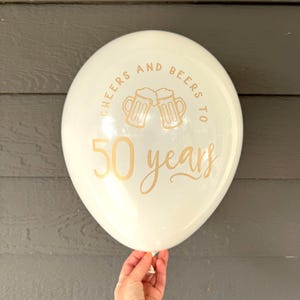 latex white and gold balloon that reads cheers and beers to 50 years.  50th Birthday Balloons