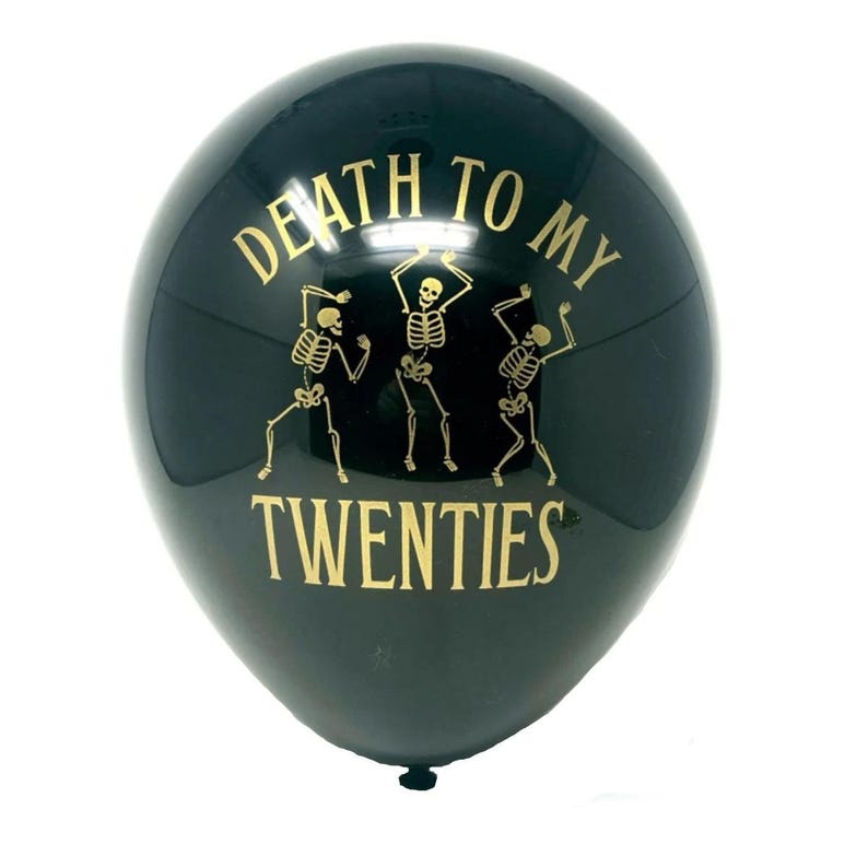 Black latex balloon that reads Death to my 20's in gold text with dancing skeletons.  30th Birthday Balloon black and gold