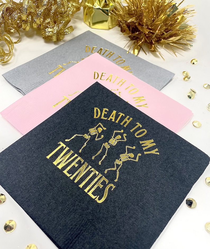 Black Pink and Gray Napkins that read Death To My Twenties Stamped in gold foil, with 3 dancing skeletons in the middle.
30th Birthday Napkins