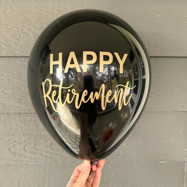 black latex balloon with gold lettering that reads "HAPPY Retirement". Black and gold retirement balloons