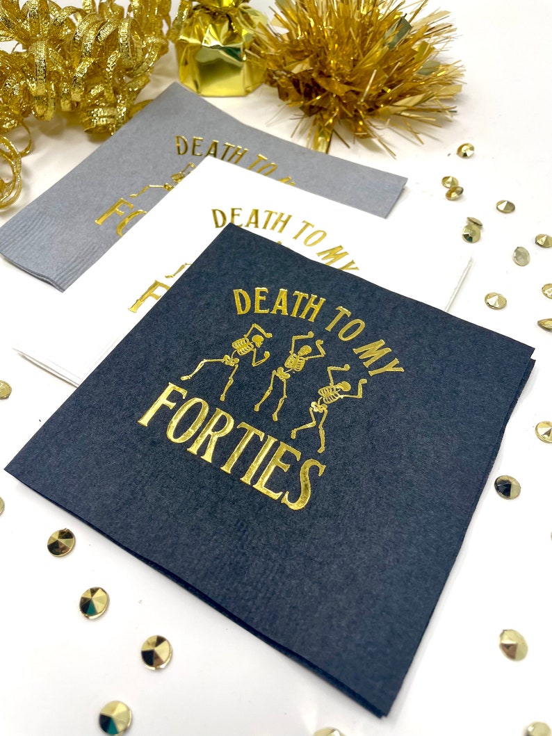 50th Birthday cocktail Napkins.  The napkins are stamped in gold foil and read Death to my Forties.  With Skeletons on the napkins.  50th Table Decor