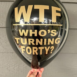 Black Latex Balloon that reads WTF Who's turning forty? in a gold metallic font.  40th Birthday Decorations