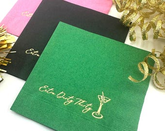 May include: Three square napkins in pink, black, and green with gold foil lettering. The green napkin has the text "Extra Dirty Thirty" and a gold martini glass with olives.