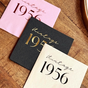 Cocktail Napkins that read Vintage 1956 in a chic script font.  The drink napkins are stamped in various colors of foil.  Cream with black foil.  Black with gold foil, and pink with red foil.  These are for a 70th Milestone Celebration.  They can be used for a birthday, anniversary or any other event celebrating 70 years.