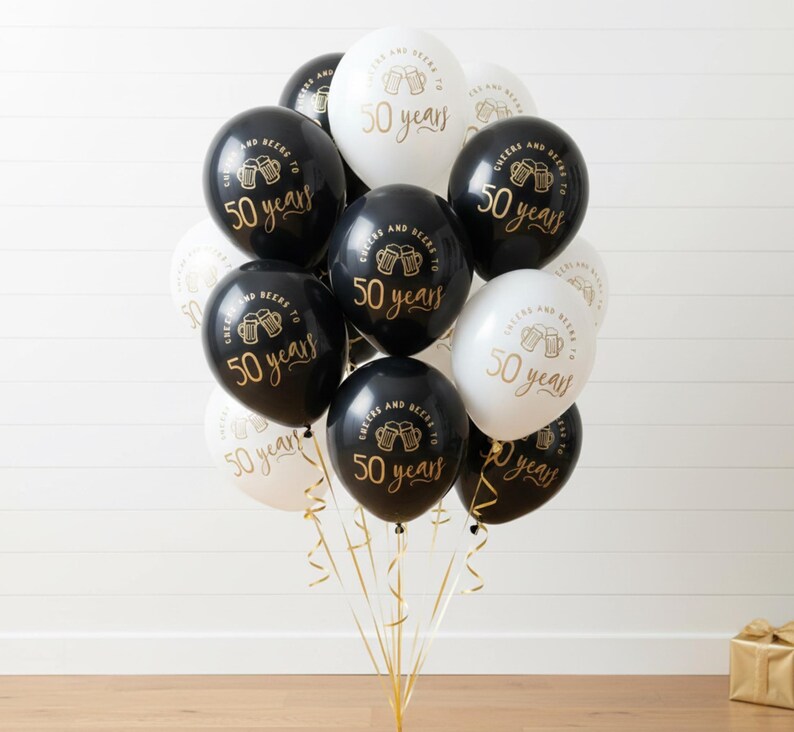 50th Milestone balloon set.  Black and White latex balloons with gold text that reads Cheers and beers to 50 years with two beer mugs.  50th Party Decorations