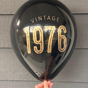 Black latex balloon that reads Vintage 1976 in a gold metallic font.  50th Birthday or Milestone Balloon