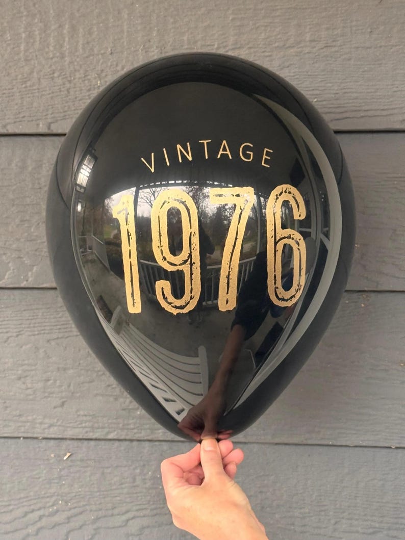 Black latex balloon that reads Vintage 1976 in a gold metallic font.  50th Birthday or Milestone Balloon