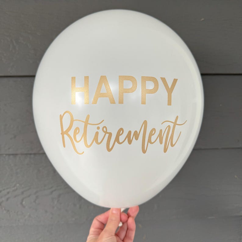 A white balloon with gold lettering that reads "HAPPY Retirement". Retirement Party Decorations