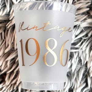 Frosted 16 ounce plastic reusable cup that reads Vintage 1986 in gold text.  40th Milestone Party Cup