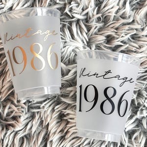 40th Birthday Frosted Plastic Cups that read Vintage 1986 in gold and black text.  40th Milestone Cups Black and Gold
