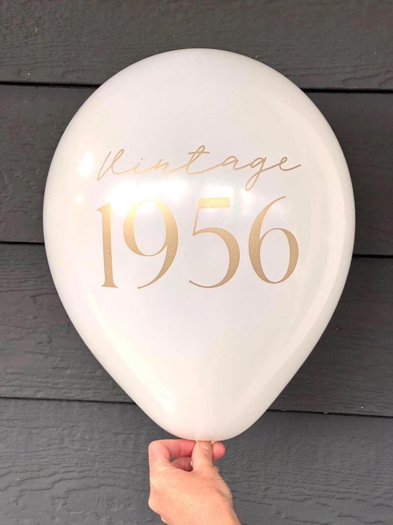 latex 12 inch balloon in white that reads Vintage 1956 in a gold metallic font.  70th Birthday Balloons