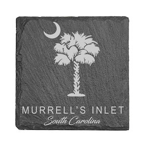 May include: A gray slate coaster with a white silhouette of a palmetto tree and crescent moon. The text "MURRELL'S INLET South Carolina" is printed below the image.
