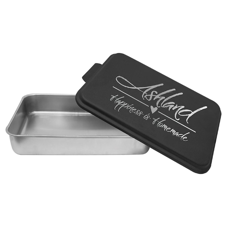 May include: Black rectangular cake pan with a silver lid. The lid has the text "Ashland Happiness is Homemade" with a small heart symbol.