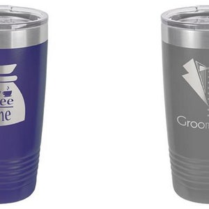 May include: Two stainless steel travel mugs. One is dark blue with "Coffee Time" and a coffee pot design. The other is gray with a tuxedo graphic and the word "Groomsman". Both have silver rims and lids.