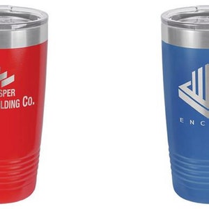 May include: Two insulated tumblers, one red and one blue, with silver rims and lids. The red tumbler features the text "Casper Building Co." and a brick design. The blue tumbler has the text "Encore" and a geometric logo.