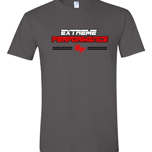 May include: A charcoal grey t-shirt with the text "EXTREME PERFORMANCE" in white and red letters. The text is underlined with two black lines.