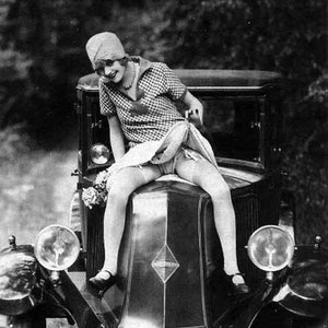 Vintage photo risque woman on antique car hood lifting skirt black and white photography print wall decor poster funny print cool gift 1920