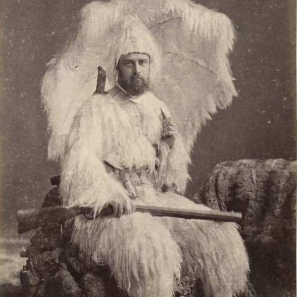 Weird strange vintage photograph man in feather suit gun hunting rifle art photograph wall decor print creepy unusual black and white 1900s