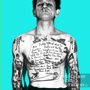May include: A black and white photo of a man with a full-body tattoo of the Lord's Prayer. The tattoo is on his chest and arms. The man is looking at the camera and has a cigarette in his mouth.
