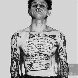 May include: Black and white photo of a man with a full-body tattoo. The tattoo is a prayer, "Our Father Which Art In Heaven, Hallowed Be Thy Name. Thy Kingdom Come. Thy Will Be Done In Earth, As It Is In Heaven. Give Us This Day Our Daily Bread. And Forgive Us Our Trespassing As We Forgive Them That Trespass Against Us. And Lead Us Not Into Temptation; But Deliver Us From Evil. Amen."