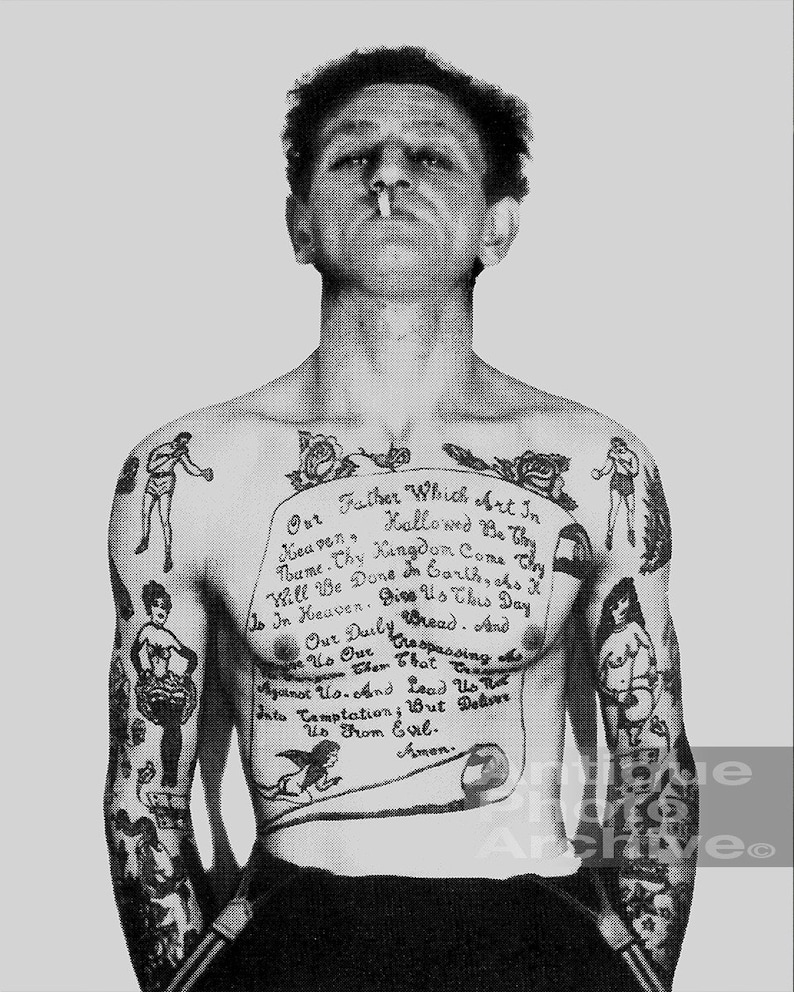 May include: Black and white photo of a man with a full-body tattoo. The tattoo is a prayer, "Our Father Which Art In Heaven, Hallowed Be Thy Name. Thy Kingdom Come. Thy Will Be Done In Earth, As It Is In Heaven. Give Us This Day Our Daily Bread. And Forgive Us Our Trespassing As We Forgive Them That Trespass Against Us. And Lead Us Not Into Temptation; But Deliver Us From Evil. Amen."