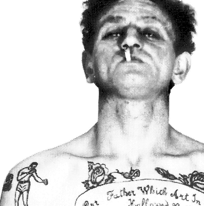 May include: Black and white photo of a man with a tattoo on his chest. The tattoo features a boxer, a rose, and the text "Our Father Which Art In Heaven."