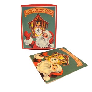 May include: Vintage Christmas-themed box and card featuring Santa Claus and a cuckoo clock. The box and card have a red border and the text "SANTA'S CUCKOO CLOCK" in gold lettering. The background is green.