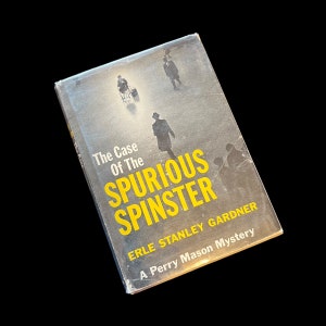May include: A vintage paperback book titled "The Case of the Spurious Spinster" by Erle Stanley Gardner. It is a Perry Mason mystery.