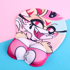 May include: A pink and white mouse mat featuring a cartoon image of a red-haired, red-eyed, and white-furred character with a pink heart-shaped chest. The character is wearing a pink and white outfit and has a black and white pattern on its face.