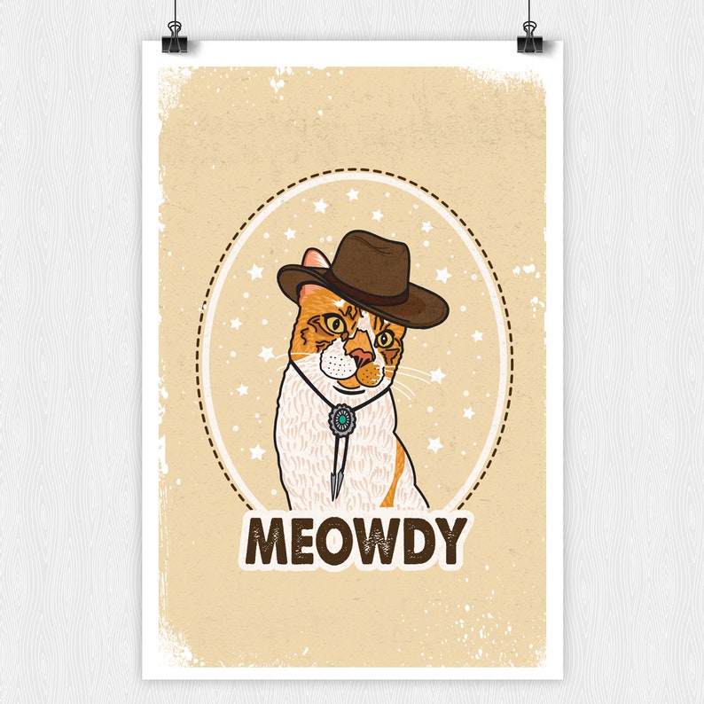 May include: A cartoon illustration of a cat wearing a cowboy hat and a bolo tie. The cat is orange and white and has a brown nose. The background is a light brown with a white star pattern. The text "MEOWDY" is written below the cat.