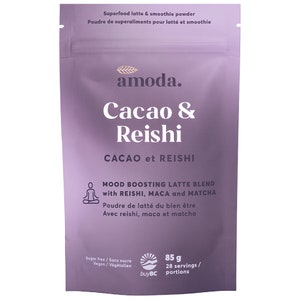 May include: A lavender pouch of "amoda" Cacao & Reishi superfood latte and smoothie powder. The package includes text in English and French, with details on ingredients and serving size of 85 g.