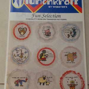 May include: A sheet of iron-on transfer patterns featuring various designs, including horses, a pig, a turtle, a sheep, and a clown. The patterns are surrounded by white lace and have a red, white, and blue color scheme. The sheet is labeled "Punchkraft Fun Selection 18 Quality Iron-On Transfer Patterns".