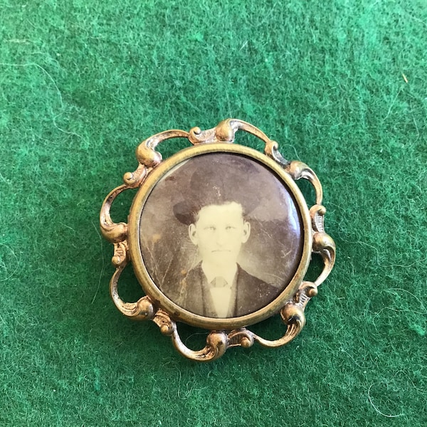 Antique Photo Brooch - Young Man in Suit W/Black Hat Perched on His Head - Swirling Metal Ribbon Surrounds Frame - Case 5-Item 19
