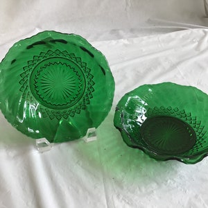 May include: Two green glass bowls with a diamond pattern. The larger bowl is a serving dish and the smaller bowl is a salad bowl.