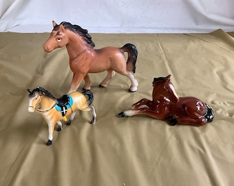Collection of 3 Horse Figurines - 2 Are Ceramic - 1 is Plastic - The Horse Lying Down was Made in Germany