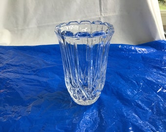 May include: A clear glass vase with a cut crystal design. The vase has a wide mouth and a narrow base.