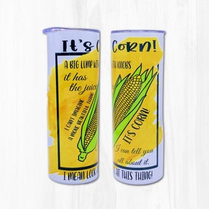 Könnte beinhalten: Ein weißer Becher mit einem gelben und grünen Design, das einen Maiskolben und den Text "It's Corn! A big lump with it has the juice. I can't imagine a more beautiful thing. I mean look at this thing!" zeigt.