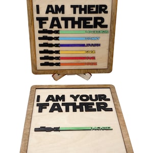May include: Wooden sign with the text "I am their father" and "I am your father" with a lightsaber graphic and names of children below each phrase.