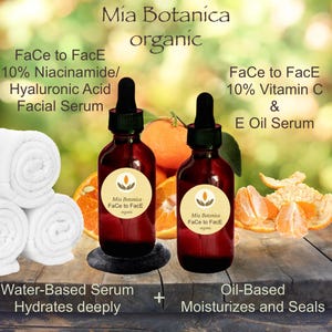 May include: Two amber glass bottles with dropper tops, labeled "Mia Botanica Face to Face organic" and containing facial serums. The bottles are on a wooden surface with orange slices and peels. The text "Face to Face 10% Niacinamide/Hyaluronic Acid Facial Serum" and "Face to Face 10% Vitamin C & E Oil Serum" is visible. The text "Water-Based Serum Hydrates deeply" and "Oil-Based Moisturizes and Seals" is also visible.