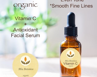 May include: A glass bottle of Mia Botanica Vitamin C organic facial serum. The bottle has a brown label with the brand name and product name. The bottle is sitting on a white surface. The text on the label reads "Mia Botanica Vitamin C organic".