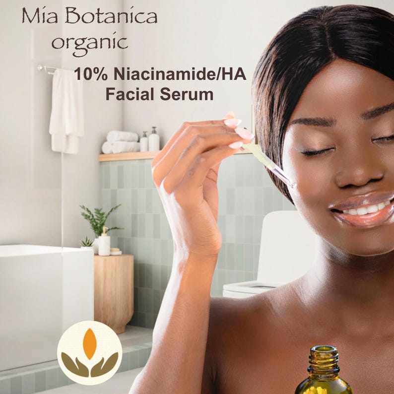May include: A woman with dark skin is applying a facial serum. The bottle is labelled "Mia Botanica organic 10% Niacinamide/HA Facial Serum".