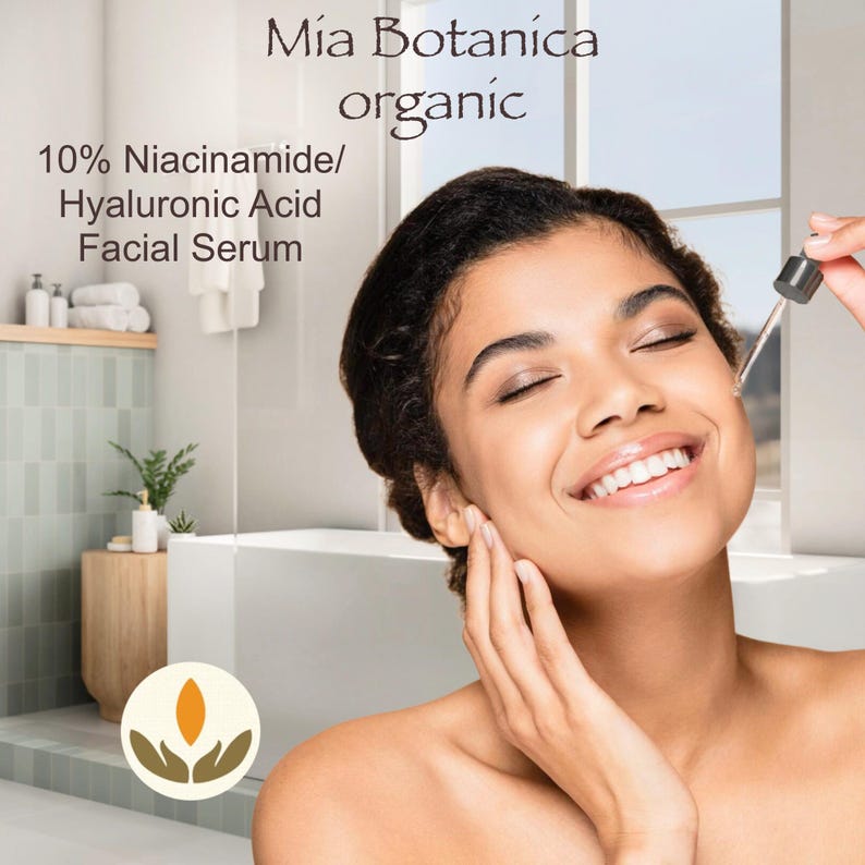 May include: A woman smiles as she applies a clear serum to her face. The product is labelled "Mia Botanica organic 10% Niacinamide/Hyaluronic Acid Facial Serum".