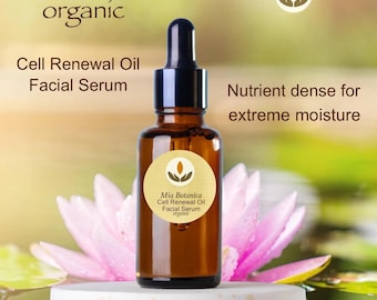May include: A brown glass bottle with a dropper top, labeled "Mia Botanica Cell Renewal Oil Facial Serum organic". The bottle is sitting on a white surface with a pink water lily in the background. The text "Nutrient dense for extreme moisture" is visible in the upper right corner of the image.