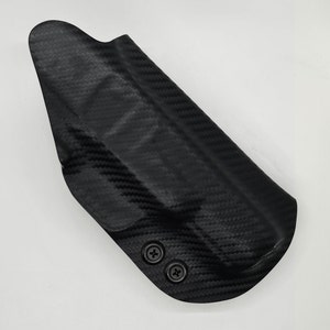 May include: A black carbon fiber holster with two screws.