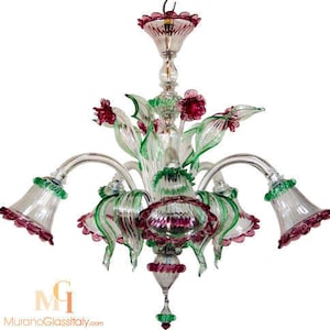 May include: A chandelier with a floral design, featuring pink and green glass flowers. The chandelier has six arms and is made of clear glass.