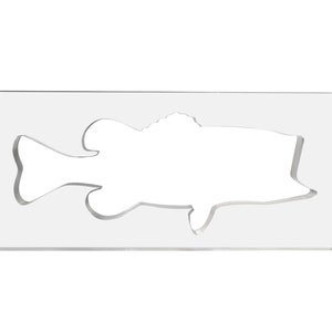 May include: A clear acrylic stencil featuring a fish outline. The fish is cut out of the rectangular stencil, creating a negative space design. The stencil is designed for crafting or artistic projects.
