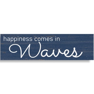 May include: A blue wooden sign with white text that reads "happiness comes in Waves".