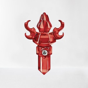May include: A red crystal-shaped video game controller with a flame design. The controller has a black button with a flame symbol on it.