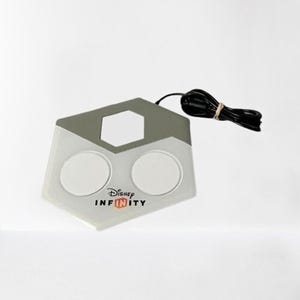 May include: A gray and white Disney Infinity base station with two circular pads and a power cord. The base station has the Disney Infinity logo on the front.