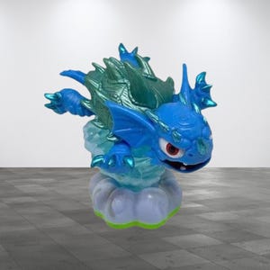 May include: A blue and green fantasy creature figurine with red eyes and a cloud base. The figure has a spiky, textured back and wings. The base is a light blue and white cloud with a green trim.